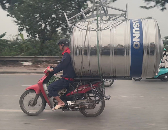 A massive water tank on a motorcycle in Vietnam 