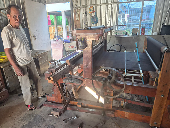Gentleman on a spinning loom for silk Cambodia 2025
