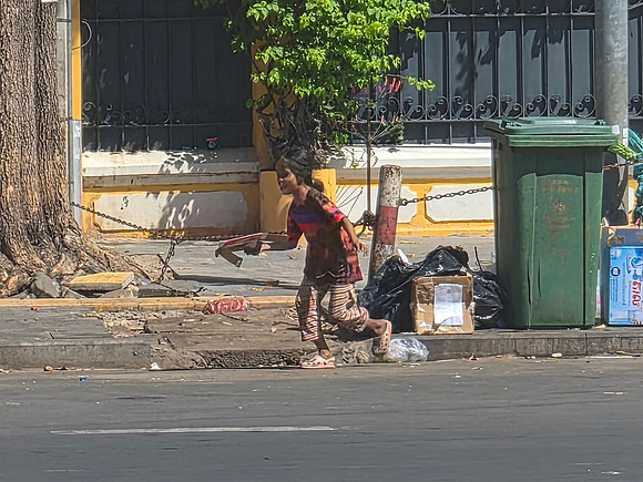 Cambodian child in litter bin