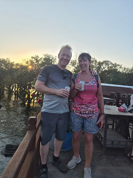 Cambodian Lake House on Stilts having a beer