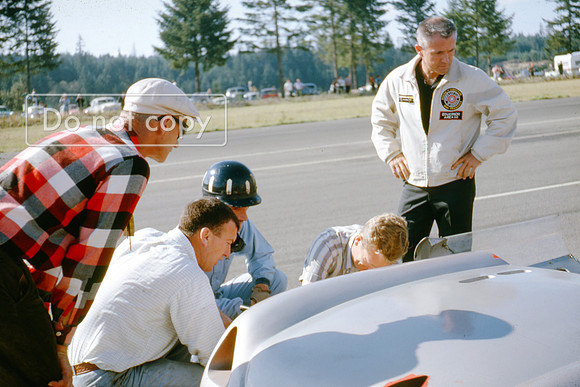 Graham Hill inspects the Lotus 23b Pacific North west Grand Prix Kent 1963